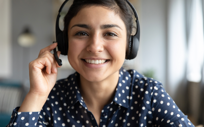 Female virtual assistant with headset smiling into the camera